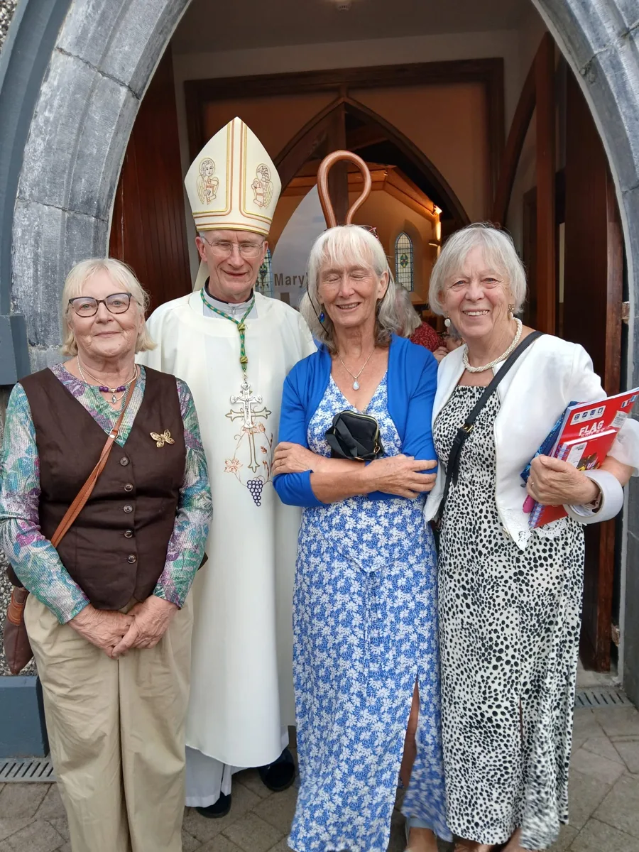 A group gathered outside a church entrance