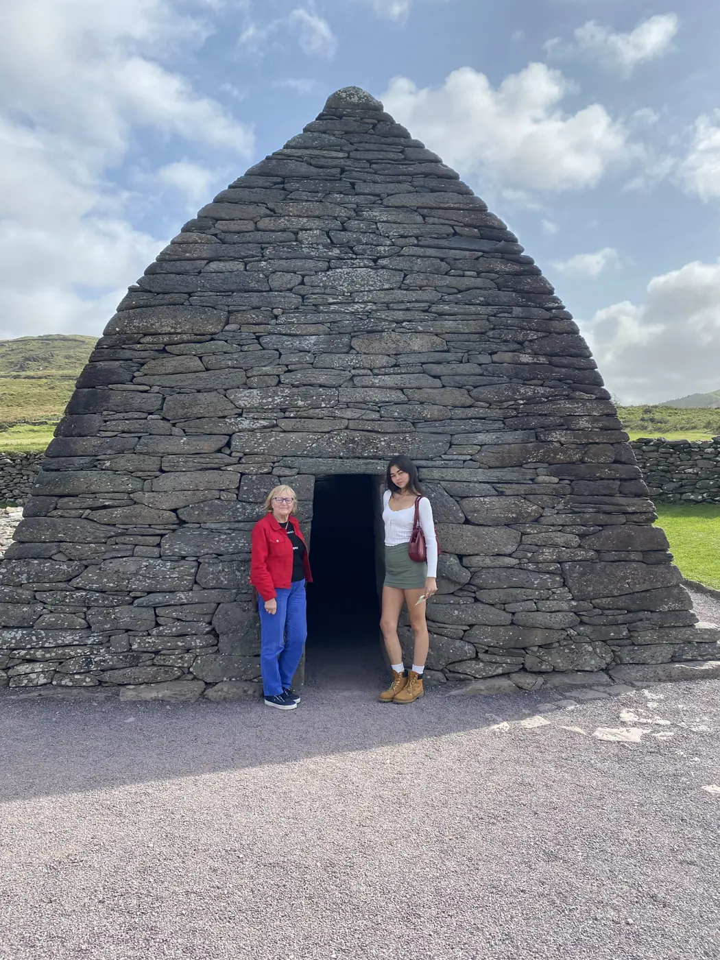 Two visitors at the entrance to Gallarus Oratory on the Dingle Peninsula