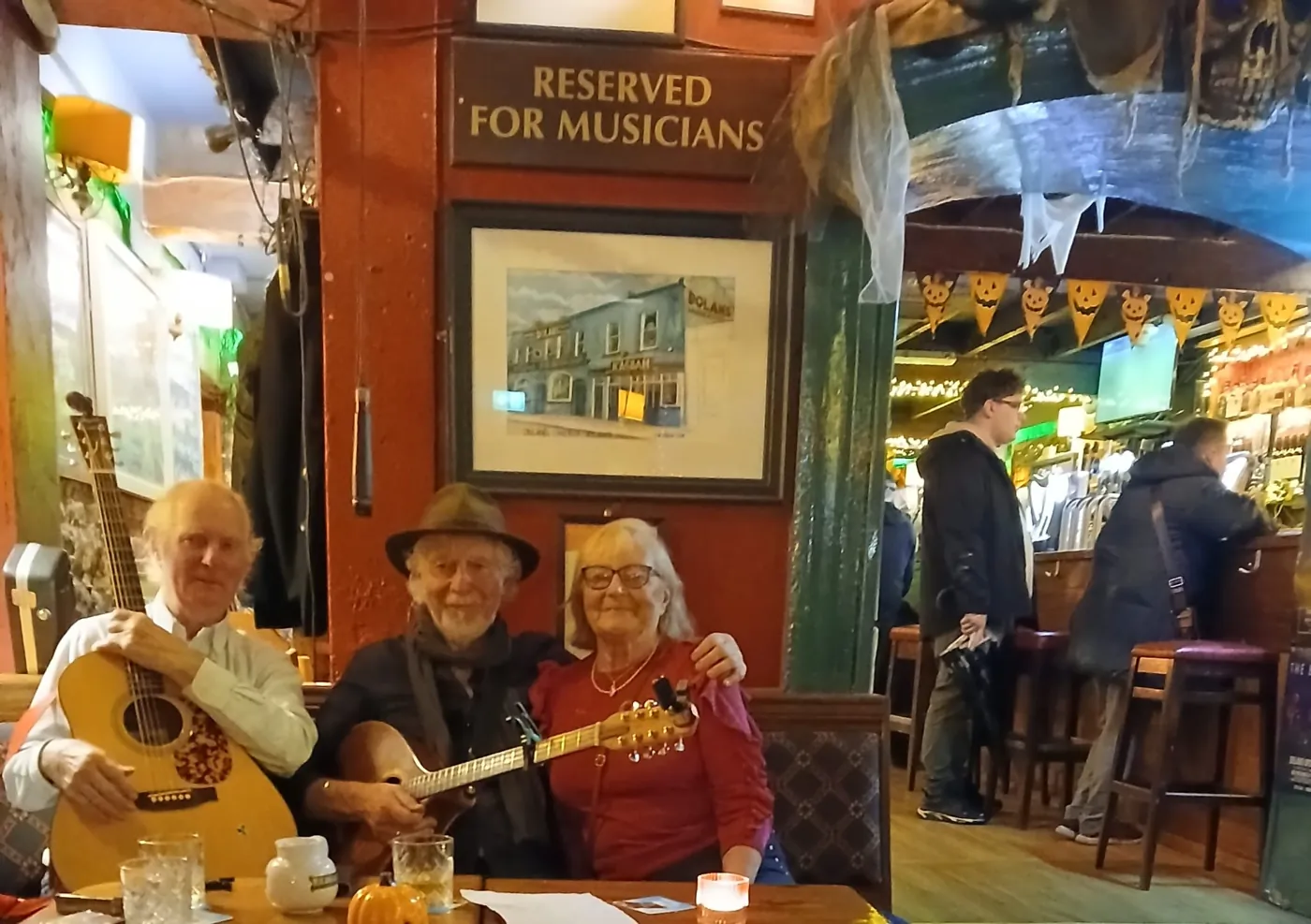 Musicians playing guitar and banjo in a pub